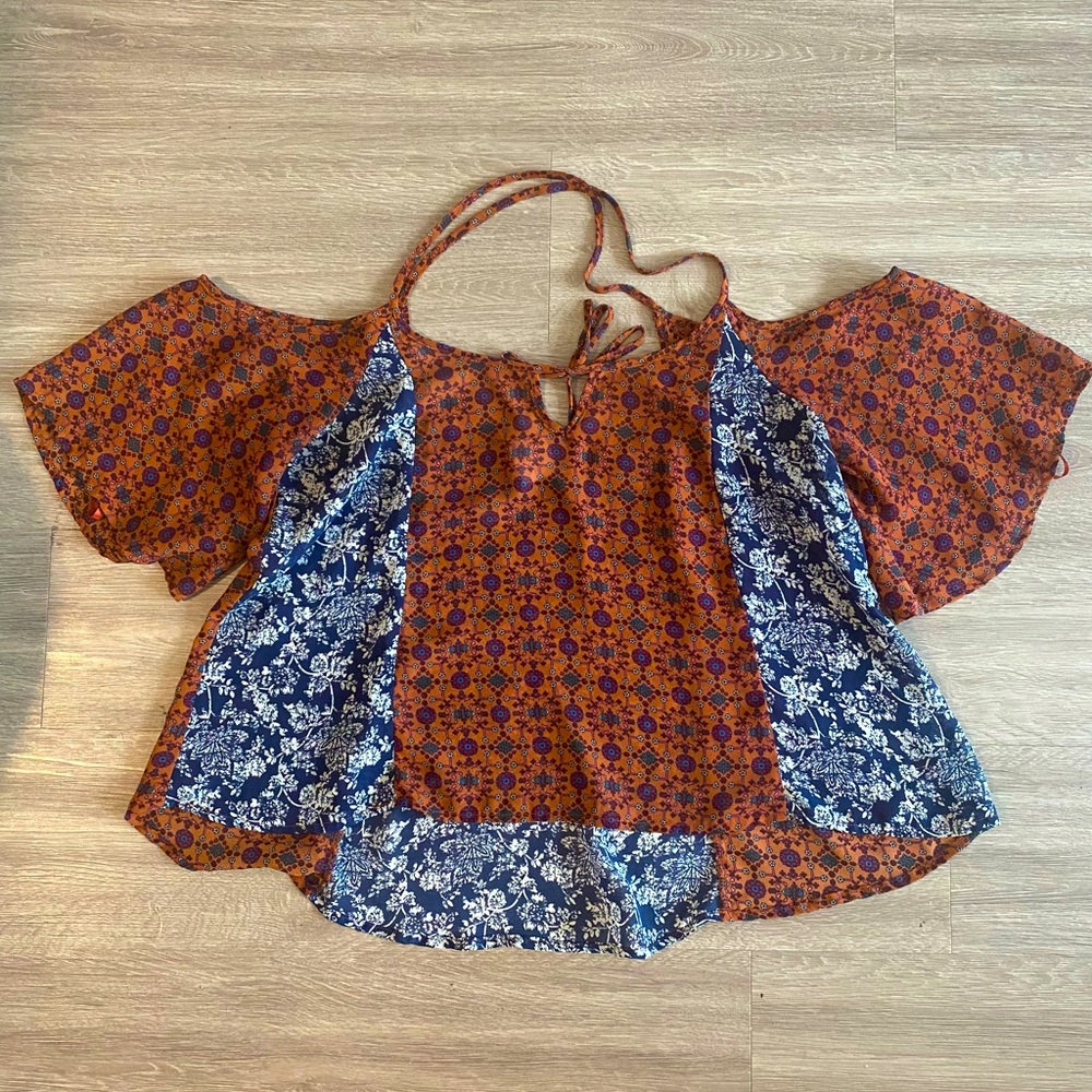 Marshall’s flowy sheer top with an open back and shoulder. Size S. brand InTu.